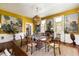 Elegant dining room with hardwood floors and a unique hanging light fixture, perfect for entertaining guests at 6 Judith St, Charleston, SC 29403