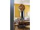 Charming dining space illuminated by an ornate hanging light fixture with views into a darker area at 6 Judith St, Charleston, SC 29403