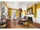 Inviting dining room featuring bright yellow walls, a fireplace, and a unique geometric light fixture at 6 Judith St, Charleston, SC 29403