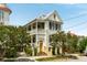 Charming two-story home with double porches, yellow front door, and mature landscaping at 6 Judith St, Charleston, SC 29403