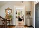 Elegant foyer with hardwood floors, decorative mirror, and a glimpse into the living room at 6 Judith St, Charleston, SC 29403