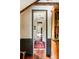 Hallway with dark wainscoting leads to room with exposed beams and comfortable seating at 6 Judith St, Charleston, SC 29403