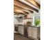 Modern kitchen with stainless steel appliances, white subway tiles, gray cabinets, and a view of the outdoors at 6 Judith St, Charleston, SC 29403