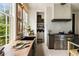 Sunlit kitchen showcasing dark cabinets, butcher block countertops, and stainless steel appliances at 6 Judith St, Charleston, SC 29403
