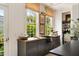 View of kitchen sink with bronze faucet, dark cabinets, butcher block counters, and bright windows at 6 Judith St, Charleston, SC 29403