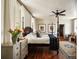 Spacious bedroom with hardwood floors, a four-poster bed, and natural light, showcasing a cozy and inviting atmosphere at 6 Judith St, Charleston, SC 29403