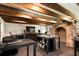 This home office has an eye-catching brick fireplace and exposed wood beam ceilings for a modern yet vintage feel at 6 Judith St, Charleston, SC 29403