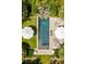 Aerial view of a stunning backyard pool with lounge chairs and umbrellas, perfect for relaxation and entertainment at 6 Judith St, Charleston, SC 29403