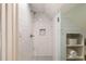 An all-tile walk-in shower features a built-in toiletry nook and adjacent built-in towel storage at 6 Judith St, Charleston, SC 29403