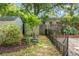 Landscaped backyard with a wooden fence, mature trees, and greenery, offering a private outdoor space at 7 Chadwick Dr # A, Charleston, SC 29407