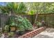 Serene outdoor patio with lush landscaping, brick accents, and a vintage bicycle for a touch of whimsy at 7 Chadwick Dr # A, Charleston, SC 29407