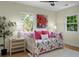 Cozy bedroom with floral bedding, a daybed, a ceiling fan, and natural light from two large windows at 7 Chadwick Dr # A, Charleston, SC 29407