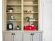Detailed view of the built-in bookcase, showcasing shelves with books, plants, and decorative items at 7 Chadwick Dr # A, Charleston, SC 29407