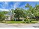 Traditional home with a stone facade, mature trees, a well-kept lawn, and desirable curb appeal at 7 Chadwick Dr # A, Charleston, SC 29407
