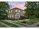 Stately two-story home with a stone exterior, beautiful landscaping, and a welcoming front yard at 7 Chadwick Dr # A, Charleston, SC 29407
