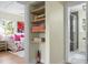 Hallway view showcasing a walk-in closet, bedroom, and an adjacent bathroom with a glass shower at 7 Chadwick Dr # A, Charleston, SC 29407