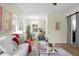 Inviting living room featuring hardwood floors, modern decor, and an open floor plan to the dining area at 7 Chadwick Dr # A, Charleston, SC 29407