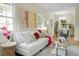Bright and airy living room featuring a white sofa, hardwood floors and modern decor at 7 Chadwick Dr # A, Charleston, SC 29407