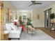 Bright living room featuring hardwood floors, white sofa, modern furnishings, and open layout to dining area at 7 Chadwick Dr # A, Charleston, SC 29407