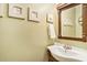 Cozy powder room featuring a framed mirror, framed beach art and a pedestal sink at 74 Mariners Cay Dr, Folly Beach, SC 29439