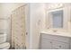Bright bathroom featuring a vanity with mirror and shower with seashell curtain at 74 Mariners Cay Dr, Folly Beach, SC 29439