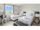 This bright twin bedroom includes matching seashell themed bedding and décor at 74 Mariners Cay Dr, Folly Beach, SC 29439