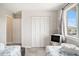 Bright twin bedroom with closet, TV, and sunny window at 74 Mariners Cay Dr, Folly Beach, SC 29439