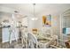 Bright dining area with glass top table and wicker chairs, adjacent to the kitchen at 74 Mariners Cay Dr, Folly Beach, SC 29439