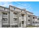 Three-story condo building featuring private balconies and neutral siding at 74 Mariners Cay Dr, Folly Beach, SC 29439
