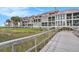 A wooden bridge leading to condos featuring screened-in porches with stunning natural views at 74 Mariners Cay Dr, Folly Beach, SC 29439