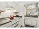 Efficient kitchen layout with bright white appliances and a view of the living area at 74 Mariners Cay Dr, Folly Beach, SC 29439