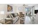 Inviting living room featuring wood floors, a sliding glass door, and comfortable seating at 74 Mariners Cay Dr, Folly Beach, SC 29439