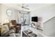 Relaxing living room featuring a TV, rocking chairs on the balcony, and nautical decor at 74 Mariners Cay Dr, Folly Beach, SC 29439