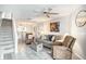 Comfortable living room featuring a ceiling fan, stairs, and a large picturesque painting at 74 Mariners Cay Dr, Folly Beach, SC 29439