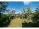 The backyard is filled with lush greenery and Spanish moss covered trees for a scenic view at 8374 Chisolm Plantation Rd, Edisto Island, SC 29438