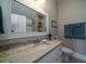 Bathroom featuring a vanity with granite countertop and framed mirror at 8374 Chisolm Plantation Rd, Edisto Island, SC 29438