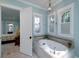 Bathroom boasting a soaking tub and views into the bedroom, offering a relaxing retreat at 8374 Chisolm Plantation Rd, Edisto Island, SC 29438