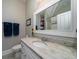 Bathroom vanity featuring granite countertop and a large framed mirror at 8374 Chisolm Plantation Rd, Edisto Island, SC 29438