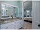 Bathroom featuring double sinks with granite countertops and a view into the bedroom at 8374 Chisolm Plantation Rd, Edisto Island, SC 29438