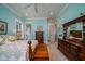 Bedroom with blue walls, a bed, and a dresser, creating a serene and stylish space at 8374 Chisolm Plantation Rd, Edisto Island, SC 29438