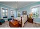 Bright bedroom with blue walls, complemented by a queen-size bed and ample natural light at 8374 Chisolm Plantation Rd, Edisto Island, SC 29438