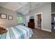 Comfortable bedroom with en suite bathroom, TV, and a pleasant view from the window at 8374 Chisolm Plantation Rd, Edisto Island, SC 29438
