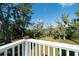 Overlooking backyard on a wood deck with white railings, enhancing the outdoor experience at 8374 Chisolm Plantation Rd, Edisto Island, SC 29438