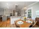 Bright dining room is attached to kitchen and features hardwood floors at 8374 Chisolm Plantation Rd, Edisto Island, SC 29438