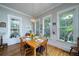 Bright dining room features hardwood floors, natural light, and wainscoting at 8374 Chisolm Plantation Rd, Edisto Island, SC 29438