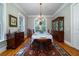 Traditional dining room with hardwood floors, a chandelier, and ample natural light at 8374 Chisolm Plantation Rd, Edisto Island, SC 29438