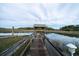 Enjoy relaxing marsh views on this wooden dock and fishing from the covered pier, perfect for coastal living at 8374 Chisolm Plantation Rd, Edisto Island, SC 29438