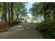 View of home and detached garage surrounded by trees and greenery at 8374 Chisolm Plantation Rd, Edisto Island, SC 29438