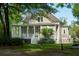 Charming home with a covered porch, surrounded by mature trees and lush greenery in a serene setting at 8374 Chisolm Plantation Rd, Edisto Island, SC 29438