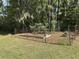 Backyard garden area with fenced garden beds, ready for planting at 8374 Chisolm Plantation Rd, Edisto Island, SC 29438